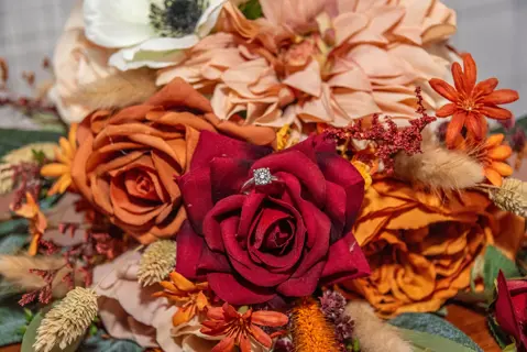 Engagement ring nestled in the autumn wedding bouquet