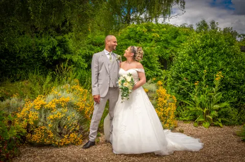 The bride and groom gaze happily at each other