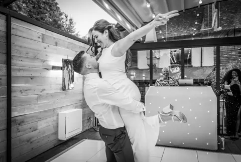 Bride leaps into her grooms arms