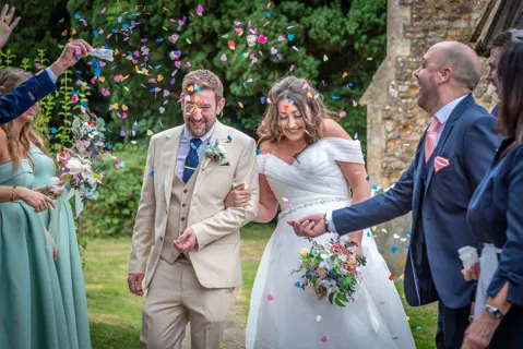 A confetti departure following the church ceremony