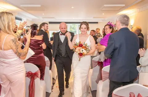 The just-married happy couple leaving their wedding ceremony