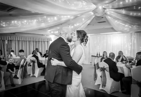 The bride and groom celebrate with a kiss during the First Dance