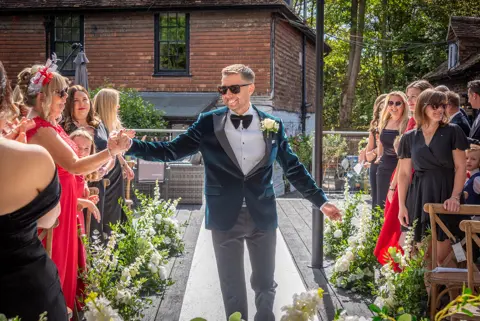 The groom arrives for the ceremony at The Buttery and Glasshouse