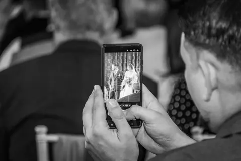 A guest joins in with the wedding photography at a Hall Place Wedding Ceremony