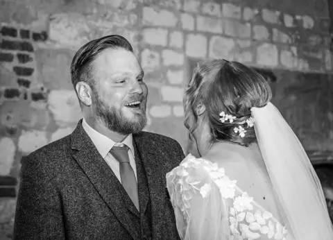 Bride and groom share a laugh during their Hall Place wedding ceremony