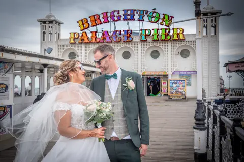 The happy couple celebrate on Brighton Pier