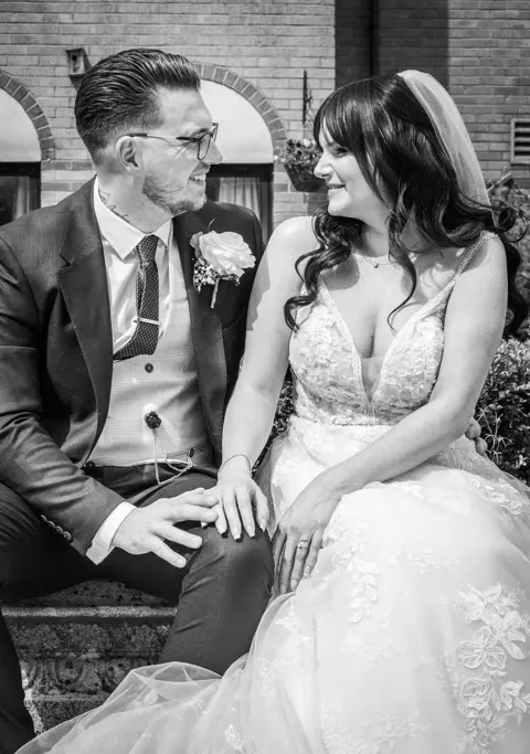 The happy couple relaxing by a fountain