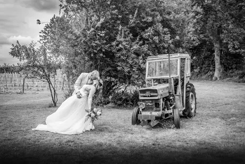 The tractor makes a feature appearance with the Bride and Groom at Seddlescombe Vineyard