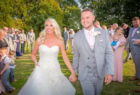 The very happy Mr & Mrs amongst their wedding guests
